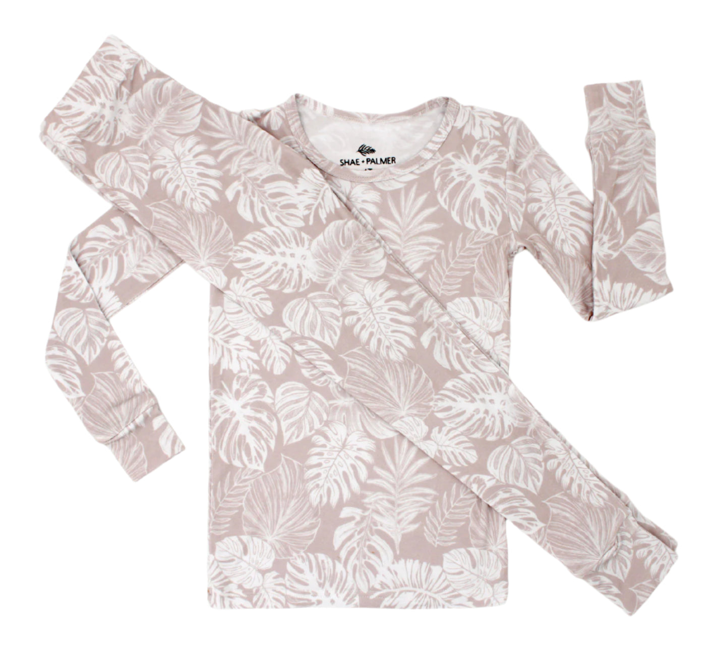 Transform your toddler’s bedtime with the luxuriously soft Tropical Bliss two-piece pajama set! Featuring a breezy palm leaf design, this set captures the essence of tropical escapes with its playful and vibrant vibe, adding a fresh twist to your little one’s nightly routine. Crafted from eco-friendly bamboo fabric, the Tropical Bliss set is ultra-soft, breathable, and gentle on sensitive skin. Bamboo’s natural temperature-regulating and moisture-absorbing properties help keep your toddler cool in warmer we