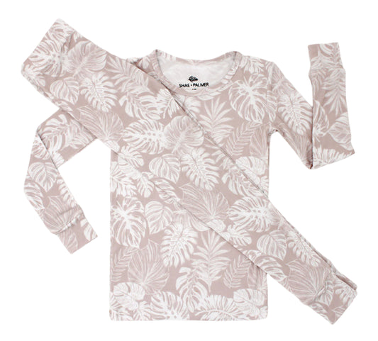 Transform your toddler’s bedtime with the luxuriously soft Tropical Bliss two-piece pajama set! Featuring a breezy palm leaf design, this set captures the essence of tropical escapes with its playful and vibrant vibe, adding a fresh twist to your little one’s nightly routine. Crafted from eco-friendly bamboo fabric, the Tropical Bliss set is ultra-soft, breathable, and gentle on sensitive skin. Bamboo’s natural temperature-regulating and moisture-absorbing properties help keep your toddler cool in warmer we