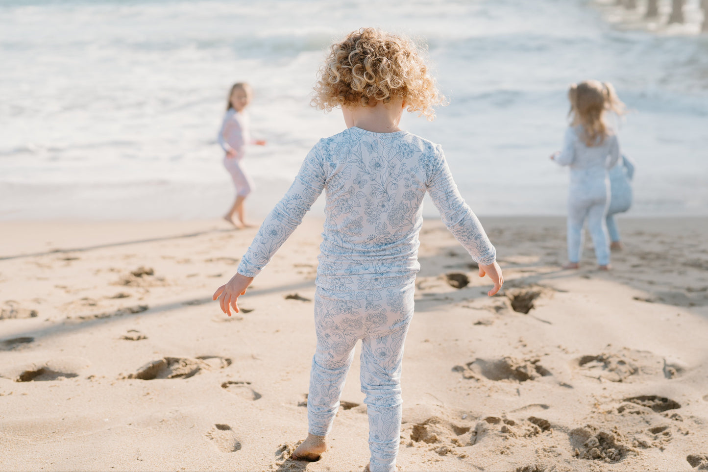 Baby and toddler bamboo pajamas in soft blue floral print — Shae & Palmer Botanical Collection in Infinity Blue, breathable luxury sleepwear for girls or boys, perfect for bedtime and playtime.
