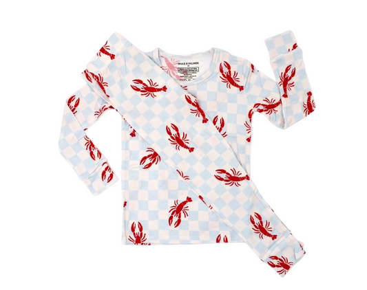 Toddler relaxing in Lobster Splash bamboo pajamas featuring coastal lobster print for cozy sleep and play
