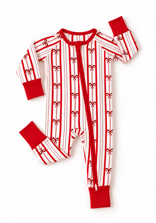 Ribbon Stripe bamboo baby romper by Shae & Palmer featuring classic red and ivory stripes with delicate bows. Soft, breathable Christmas baby pajamas perfect for holiday family photos, cozy winter nights, and matching family pajama sets.