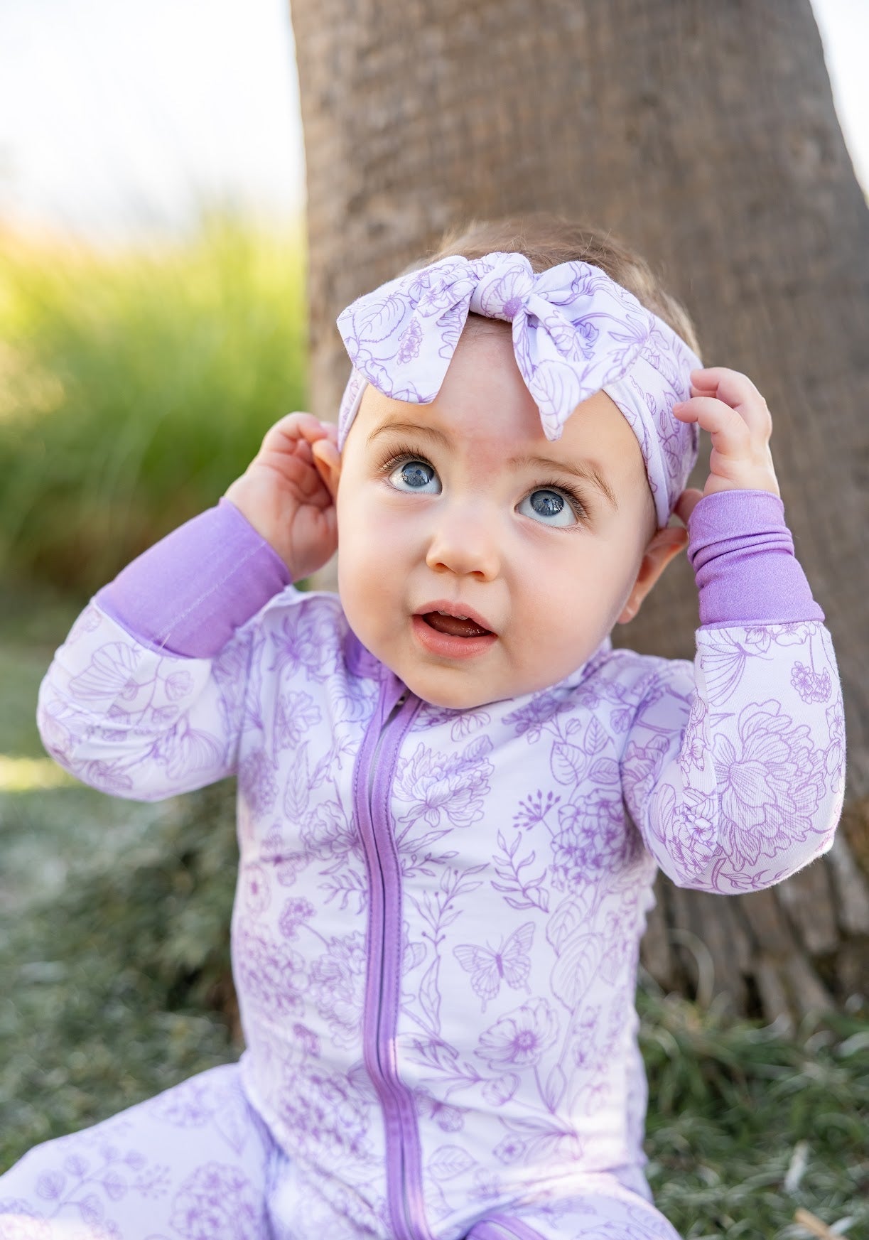 Baby wearing Shae & Palmer Botanical Lavender bamboo pajamas featuring a soft lavender floral print, double zipper design, and ultra-soft breathable bamboo fabric for cozy comfort.