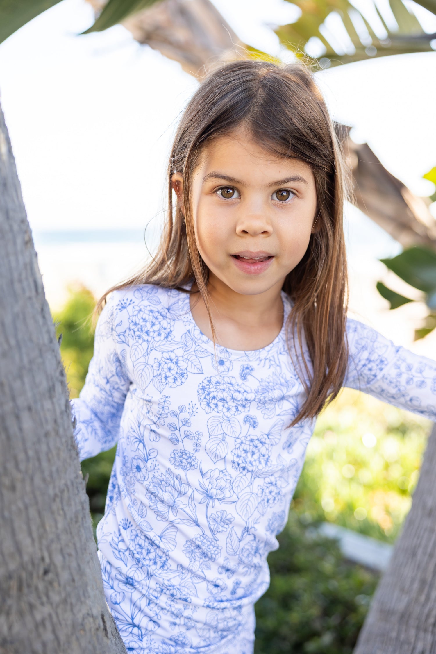Big kid wearing Shae & Palmer Botanical Blue bamboo pajamas featuring an elegant blue floral print, buttery-soft bamboo fabric, and a cozy two-piece design for sleep and lounge comfort.