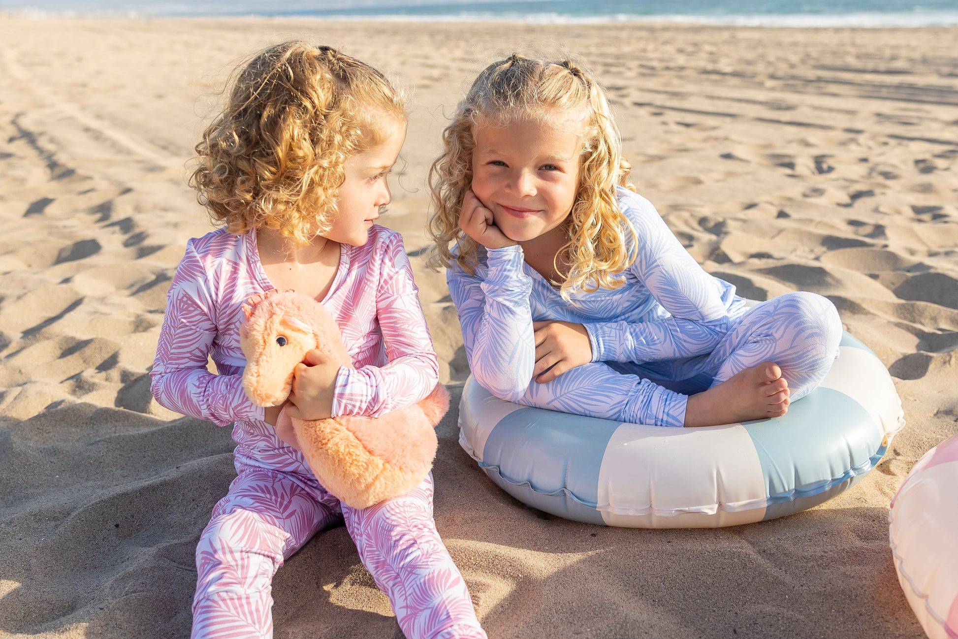 Coastal-inspired toddler bamboo pajama set in the Cali Coastal Pink palm print made from ultra-soft breathable bamboo fabric