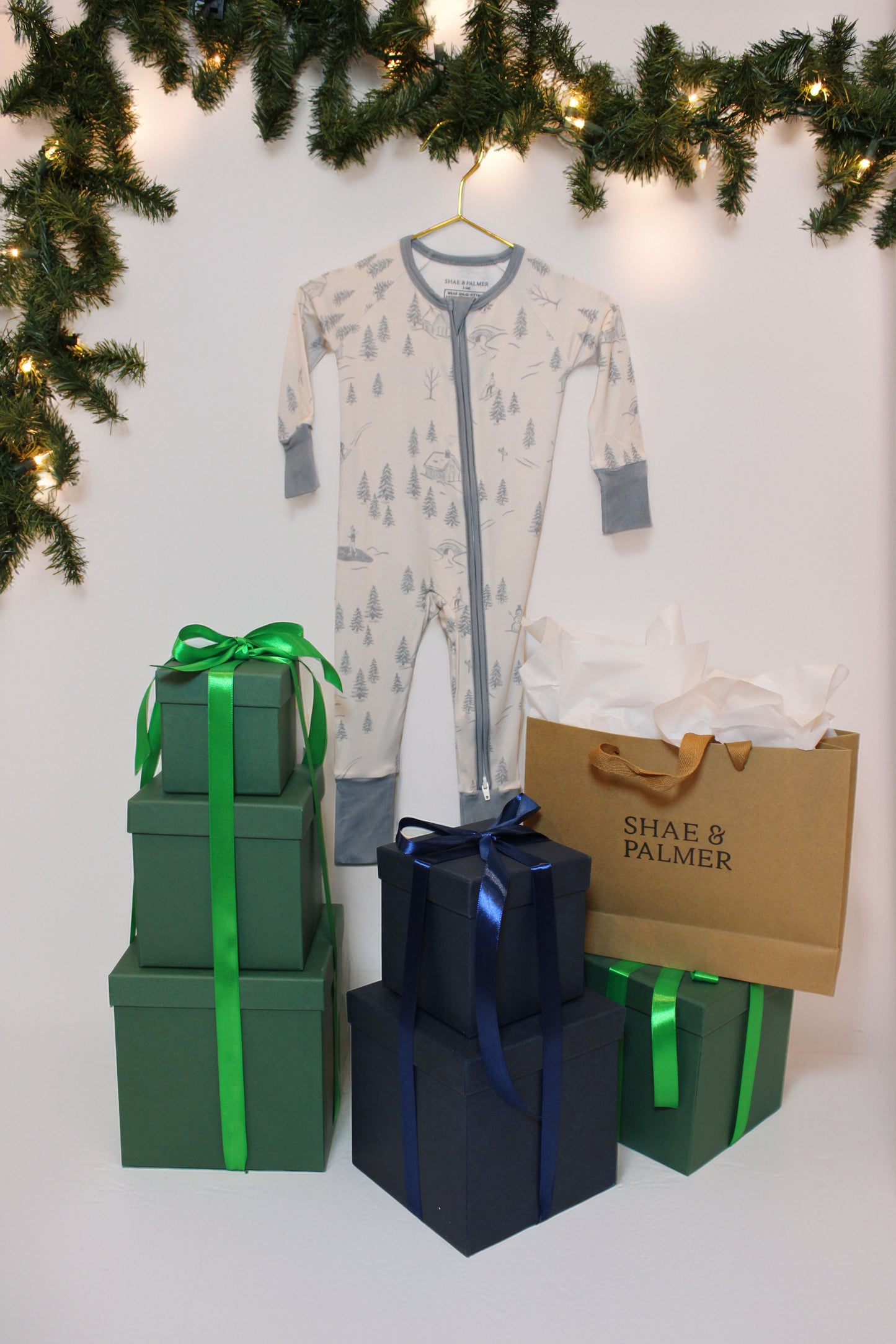 Soft bamboo baby pajamas featuring the Winterdream snow lodge print — luxury holiday sleepwear for babies by Shae & Palmer, designed for warmth and comfort.