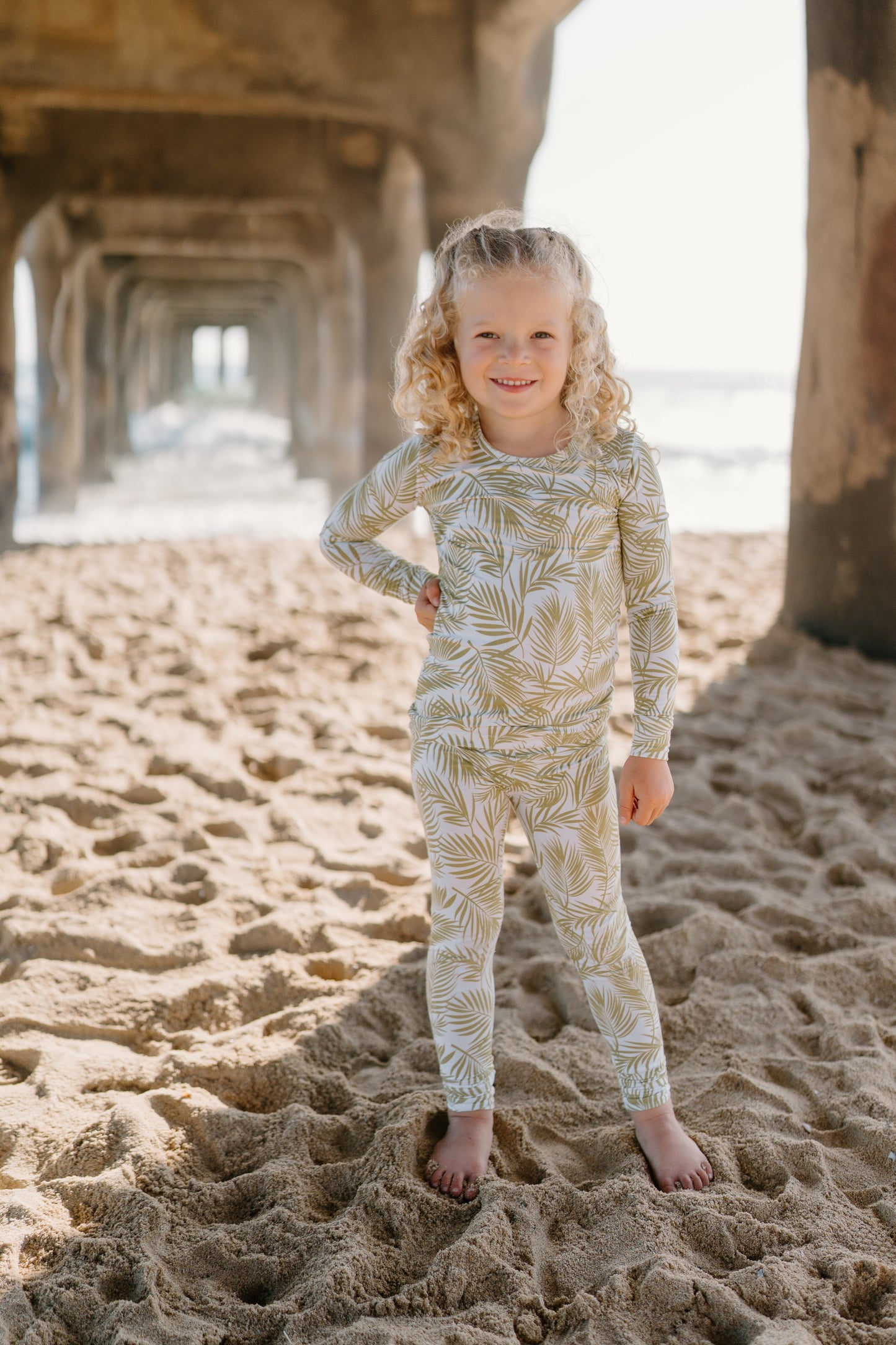 Transform your toddler’s bedtime with the luxuriously soft Cali Coastal two-piece pajama set! Featuring a breezy palm leaf design inspired by the serenity of coastal living, this vibrant print blends playfulness and style, perfect for adding a refreshing touch to your little one’s nightly routine. Crafted from eco-friendly bamboo fabric, the Cali Coastal set is incredibly soft, breathable, and gentle on sensitive skin. Bamboo’s natural temperature-regulating and moisture-absorbing properties help keep your 