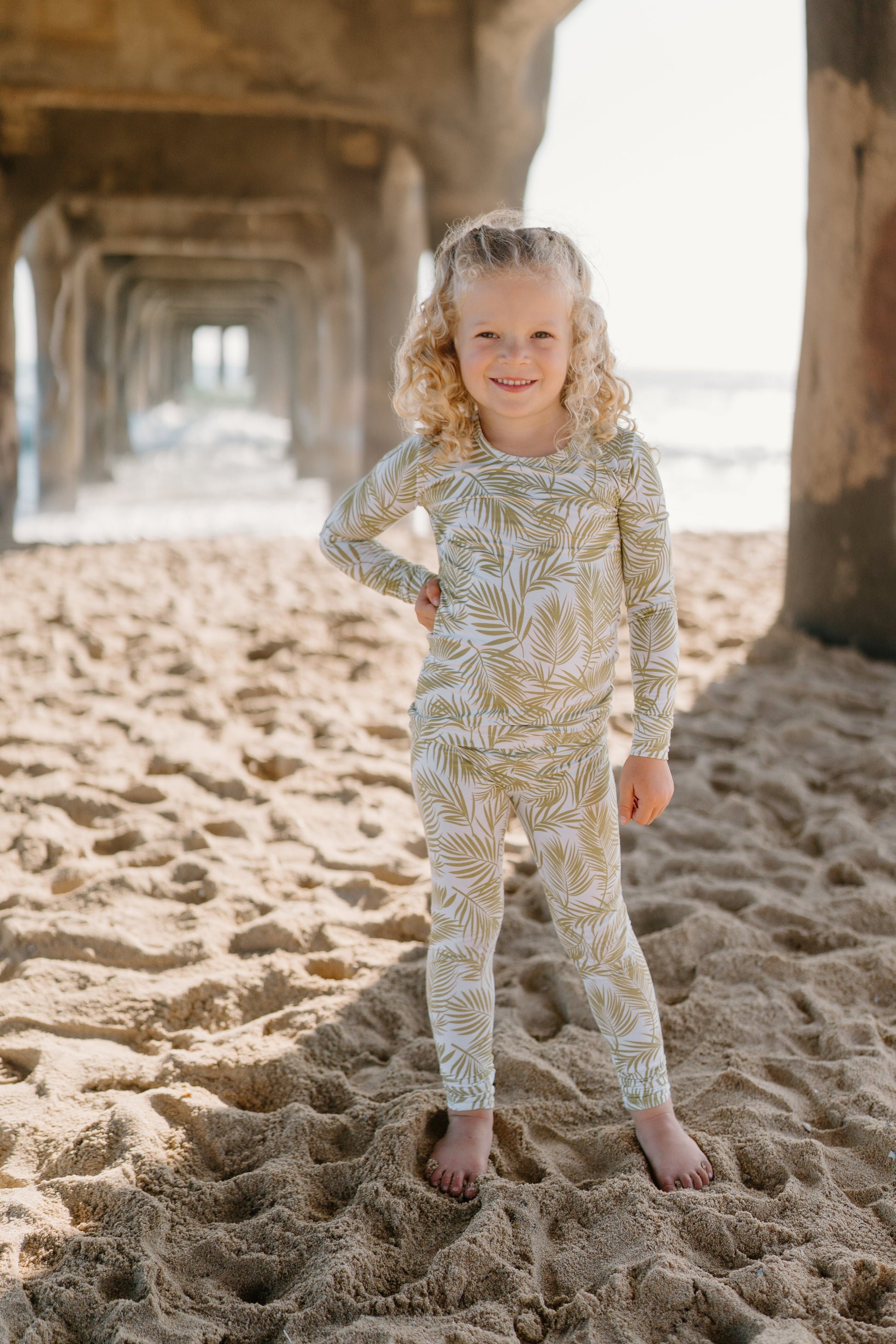 Transform your toddler’s bedtime with the luxuriously soft Cali Coastal two-piece pajama set! Featuring a breezy palm leaf design inspired by the serenity of coastal living, this vibrant print blends playfulness and style, perfect for adding a refreshing touch to your little one’s nightly routine. Crafted from eco-friendly bamboo fabric, the Cali Coastal set is incredibly soft, breathable, and gentle on sensitive skin. Bamboo’s natural temperature-regulating and moisture-absorbing properties help keep your 