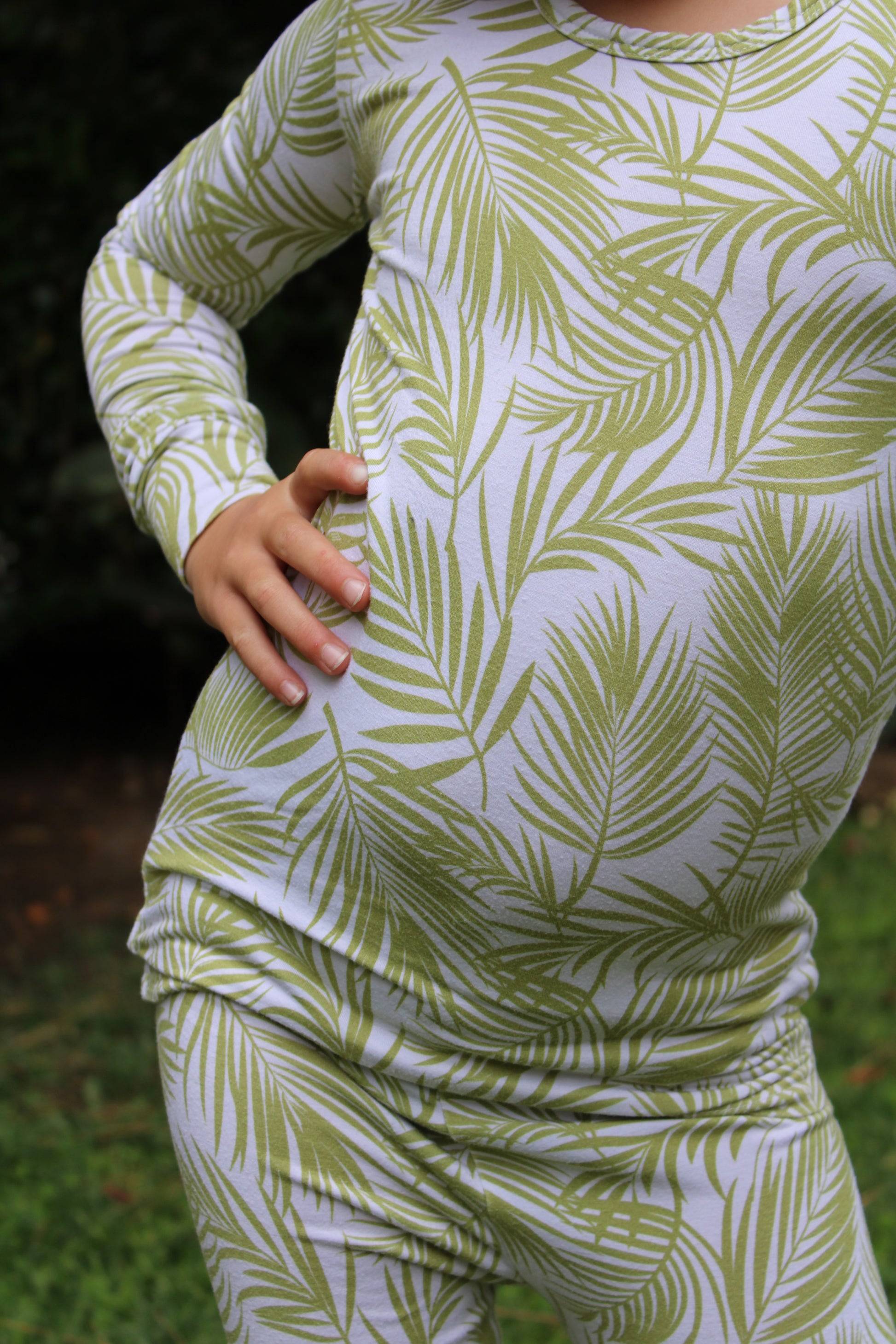 Transform your toddler’s bedtime with the luxuriously soft Cali Coastal two-piece pajama set! Featuring a breezy palm leaf design inspired by the serenity of coastal living, this vibrant print blends playfulness and style, perfect for adding a refreshing touch to your little one’s nightly routine. Crafted from eco-friendly bamboo fabric, the Cali Coastal set is incredibly soft, breathable, and gentle on sensitive skin. Bamboo’s natural temperature-regulating and moisture-absorbing properties help keep your 