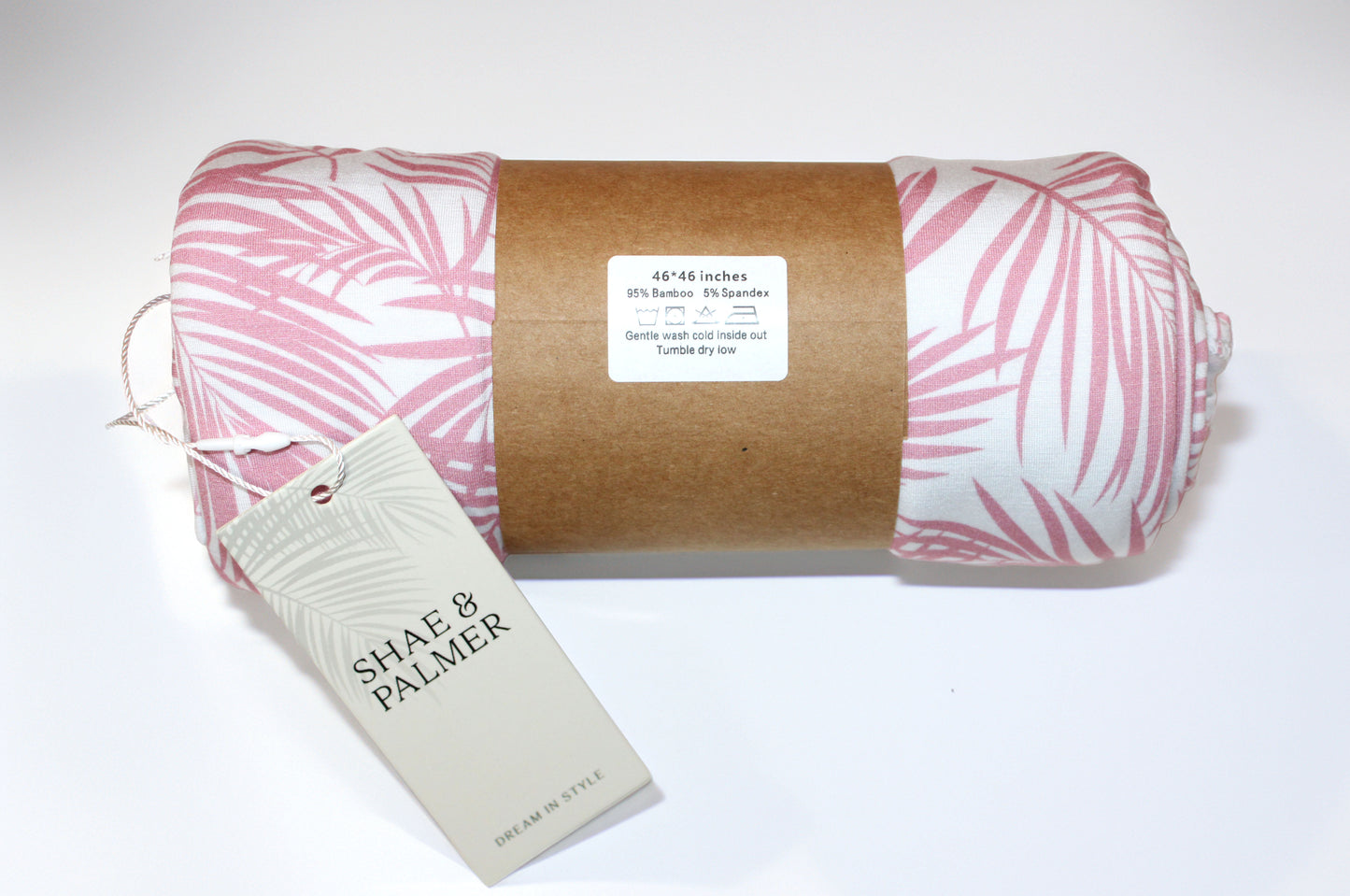 Cali Coastal pink baby swaddle blanket by Shae & Palmer — buttery-soft bamboo with tropical palm accents, ideal for cozy cuddles or travel.