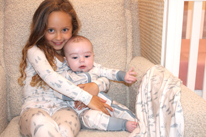 Soft bamboo baby pajamas featuring the Winterdream snow lodge print — luxury holiday sleepwear for babies by Shae & Palmer, designed for warmth and comfort. Family matching