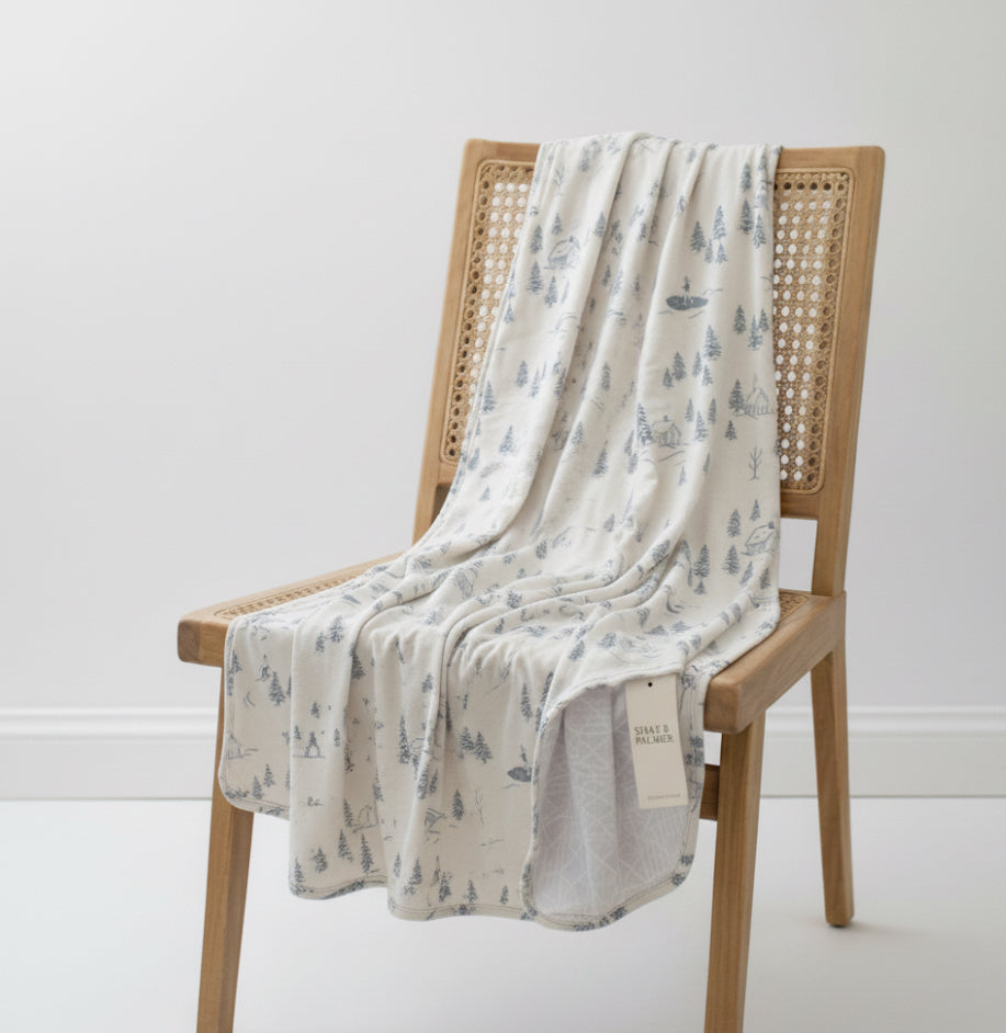 Baby wrapped in Winterdream Snow White bamboo blanket by Shae & Palmer, soft breathable temperature-regulating fabric