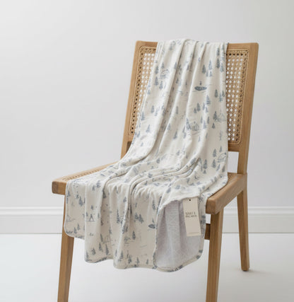 Baby wrapped in Winterdream Snow White bamboo blanket by Shae & Palmer, soft breathable temperature-regulating fabric