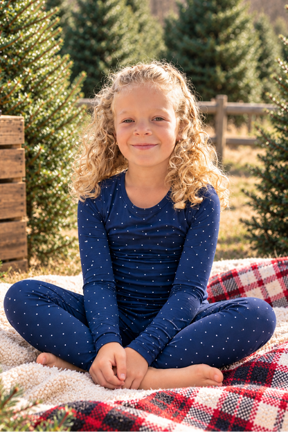 Big kids wearing navy Midnight Dot bamboo pajamas with a white dot print, soft holiday sleepwear for Hanukkah and Christmas