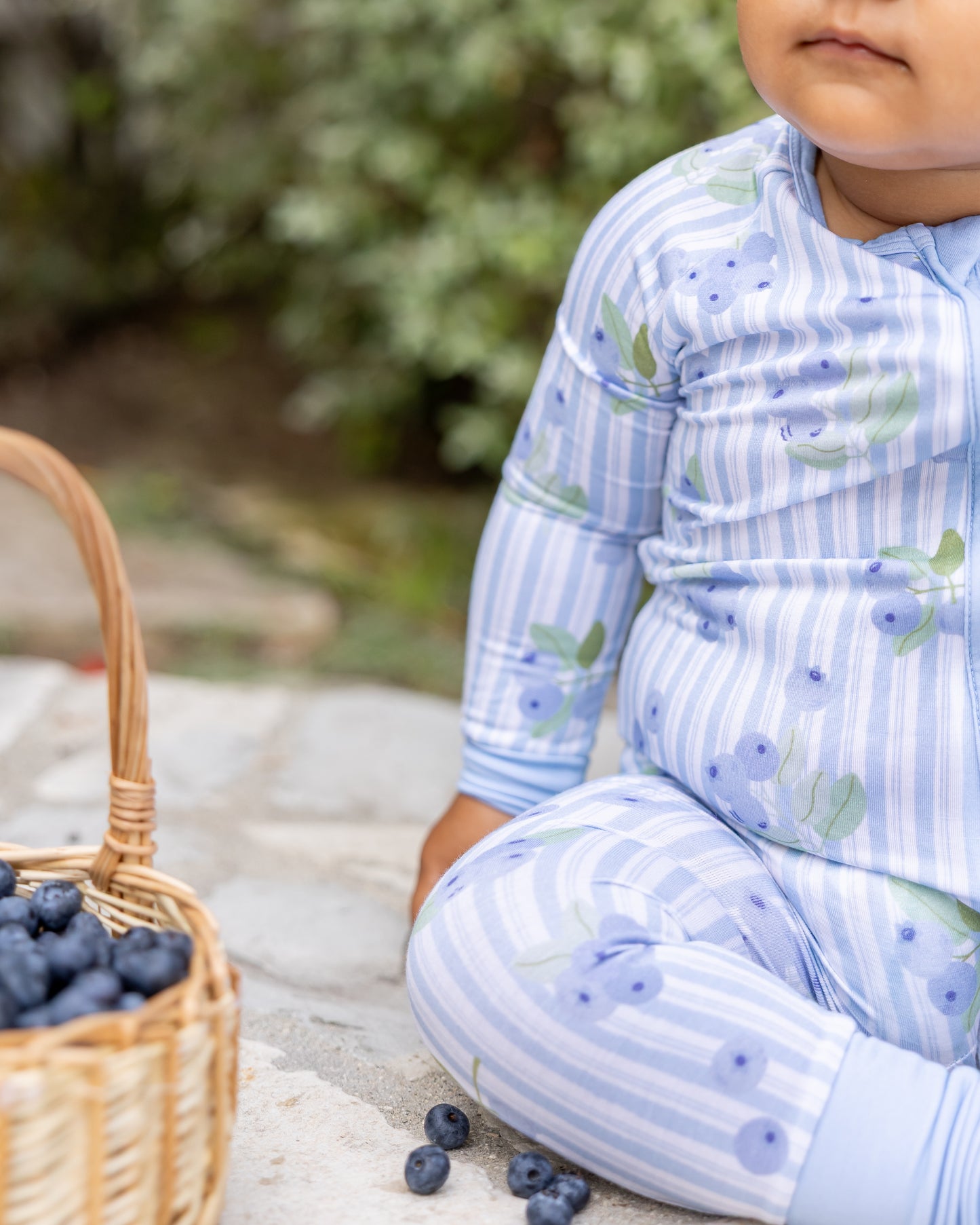 Close-up of Blueberry Lane blue striped bamboo pajamas on a baby, showing soft, breathable fabric gentle on sensitive skin
