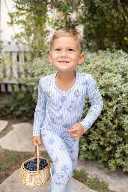 Smiling big kid boy wearing Blueberry Lane blue striped bamboo pajamas, breathable sleepwear designed for sensitive skin