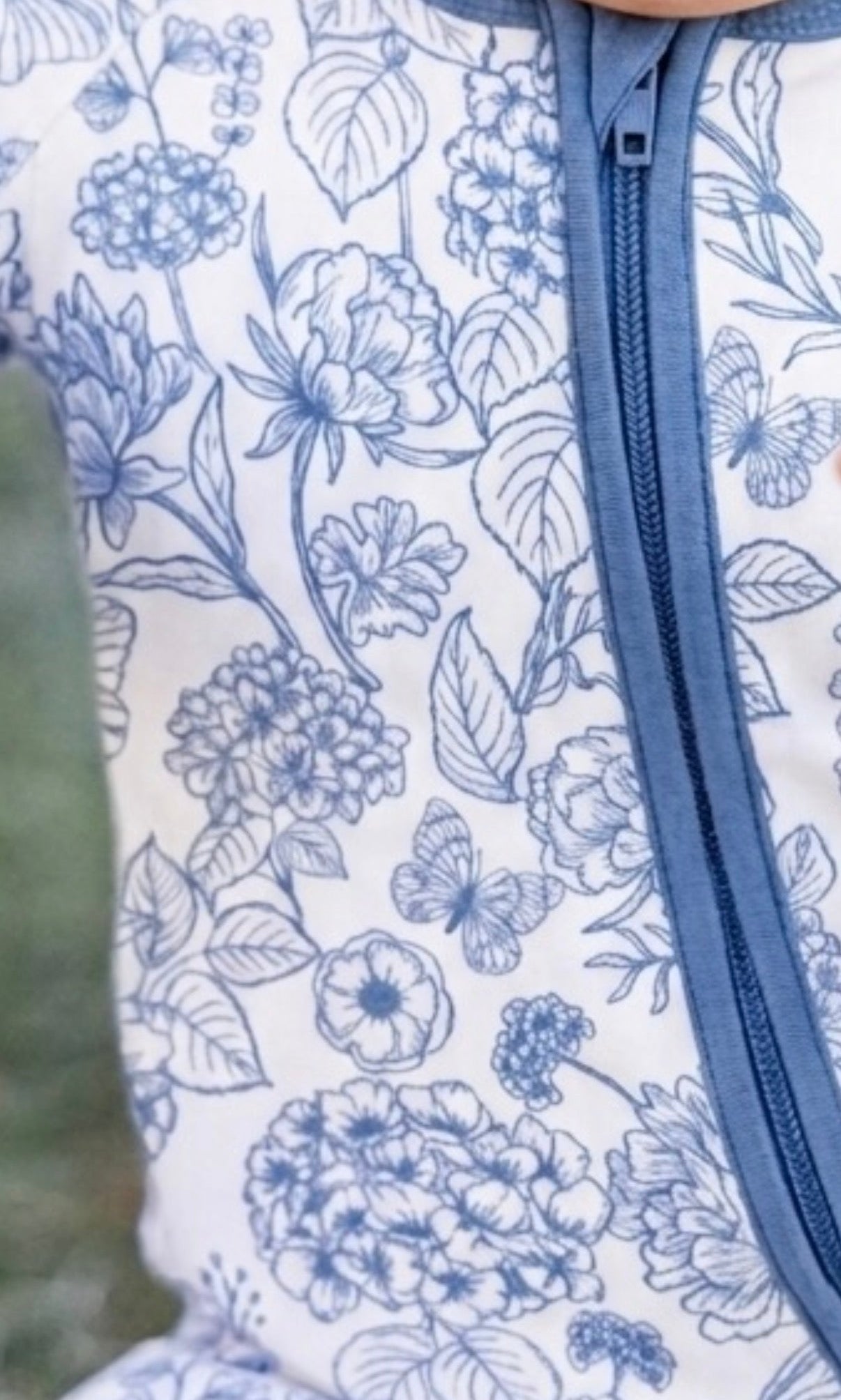 Shae & Palmer Botanical Blue bamboo baby zipper romper featuring a refined blue botanical print, buttery-soft stretch bamboo fabric, and a cozy breathable design for sleep and play.