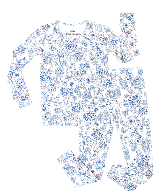 Shae & Palmer’s Botanical Blue bamboo kids romper features a timeless blue floral pattern inspired by interior design, made from ultra-soft sustainable bamboo fabric with a double zipper for easy dressing and diaper changes, perfect for babies and toddlers.
