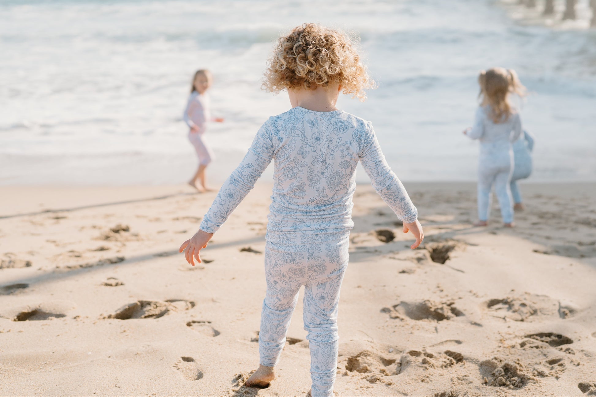 Baby and toddler bamboo pajamas in soft blue floral print — Shae & Palmer Botanical Collection in Infinity Blue, breathable luxury sleepwear for girls or boys, perfect for bedtime and playtime.