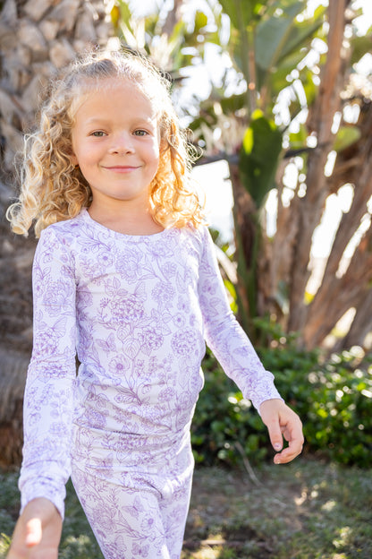 Big kid wearing Shae & Palmer Botanical Lavender bamboo pajamas featuring a soft lavender floral print on ultra-soft breathable bamboo fabric designed for cozy sleep and play.