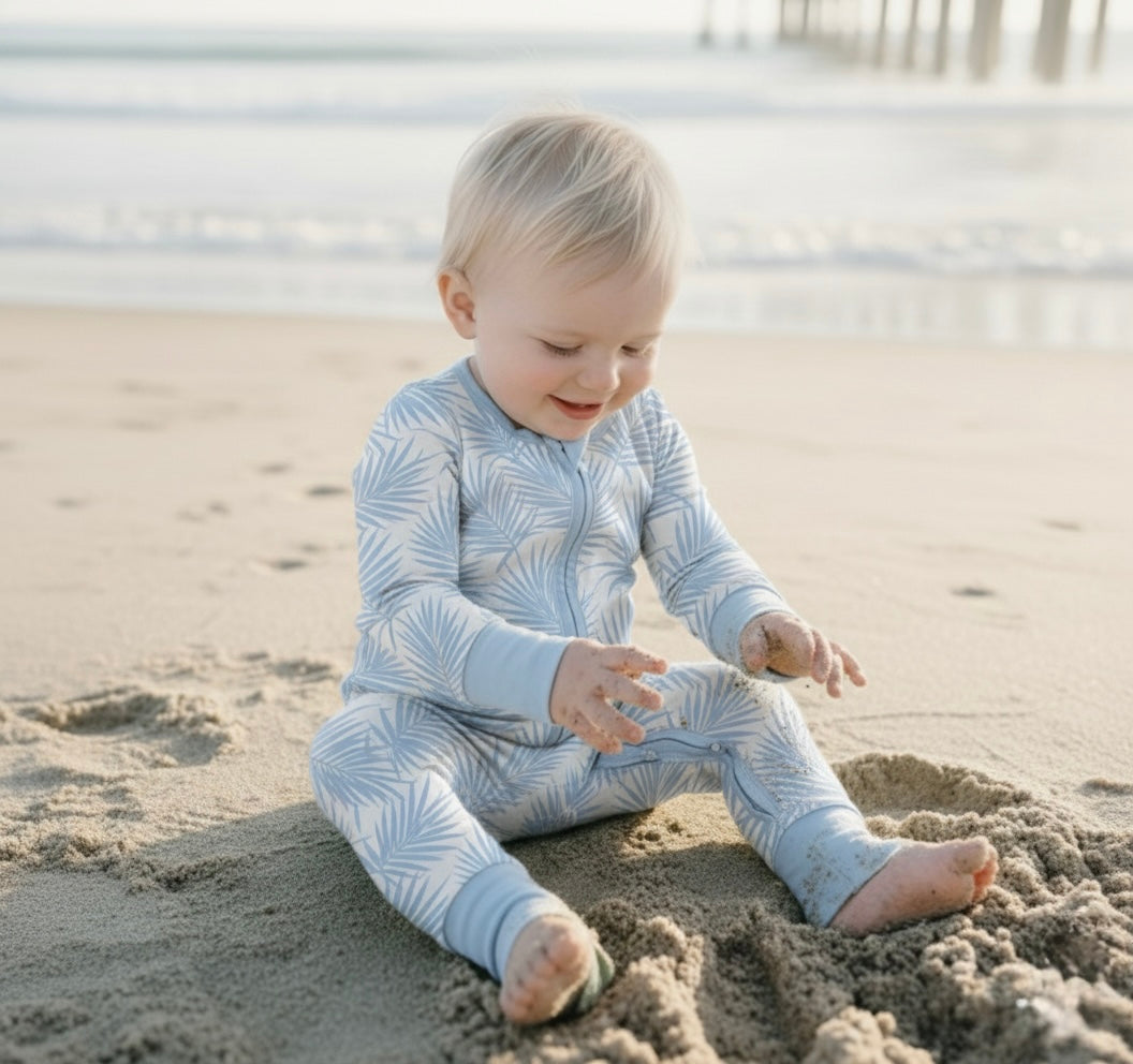 Close-up of Cali Coastal Baby Blue bamboo fabric featuring soft palm leaf pattern, gentle and breathable for sensitive baby skin