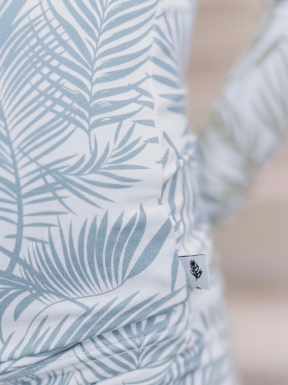 Close-up of Cali Coastal Baby Blue bamboo pajamas palm leaf print by Shae & Palmer in soft blue tones