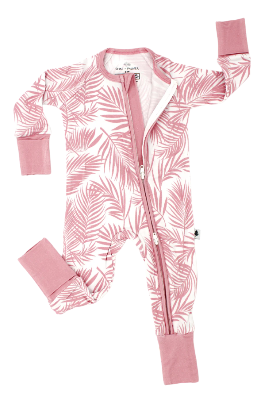 Shae & Palmer Cali Coastal Collection - bamboo baby zip romper in Pink palm leaf print. Ultra-soft, breathable zip-up pajamas with double zipper for easy diaper changes, perfect for stylish baby girls.