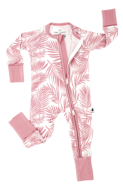 Shae & Palmer Cali Coastal Collection - bamboo baby zip romper in Pink palm leaf print. Ultra-soft, breathable zip-up pajamas with double zipper for easy diaper changes, perfect for stylish baby girls.