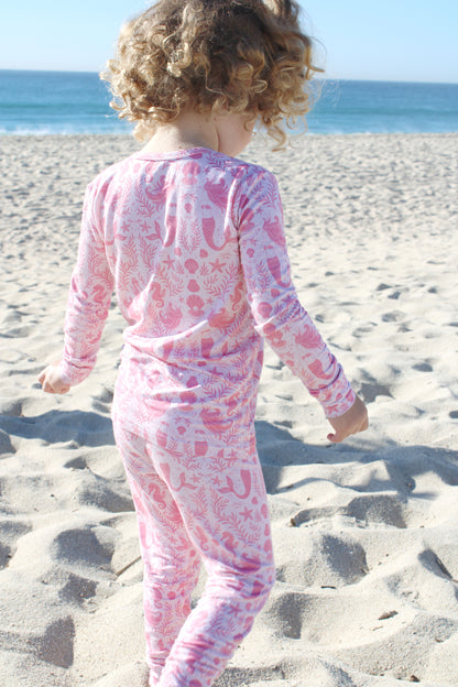 Soft bamboo toddler pajama set with mermaid and seashell print, comfortable for sleep and play.