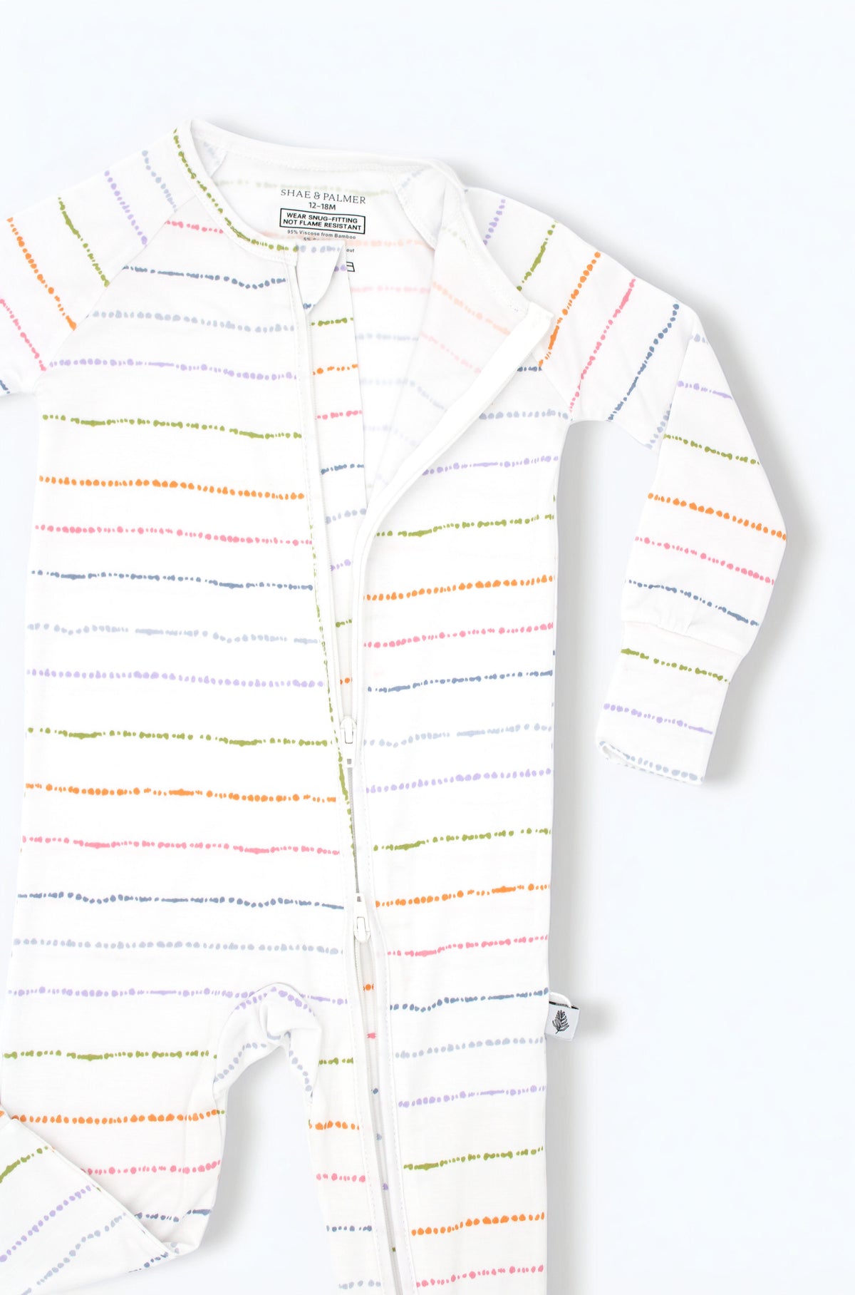 Confetti Stripe colorful bamboo baby pajama romper styled in a flat lay