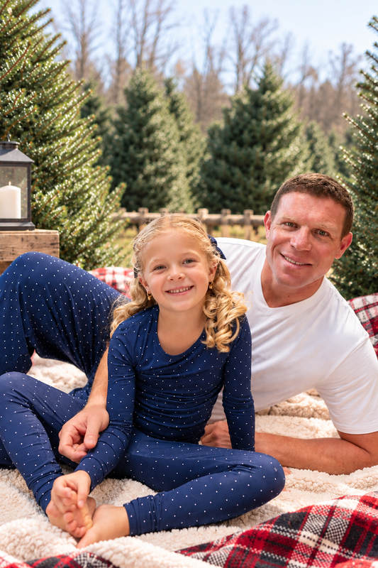 Dad and child wearing matching navy Midnight Dot bamboo pajamas for Hanukkah and Christmas family matching sleepwear