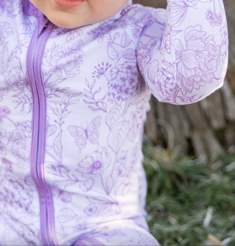 Shae & Palmer eco-conscious bamboo baby romper in Botanical Amethyst, a floral zippered pajama made with sustainable bamboo material, designed for soft, breathable comfort and everyday wear for babies and toddlers.