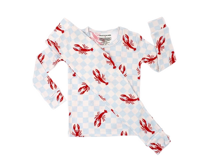Toddler relaxing in Lobster Splash bamboo pajamas featuring coastal lobster print for cozy sleep and play