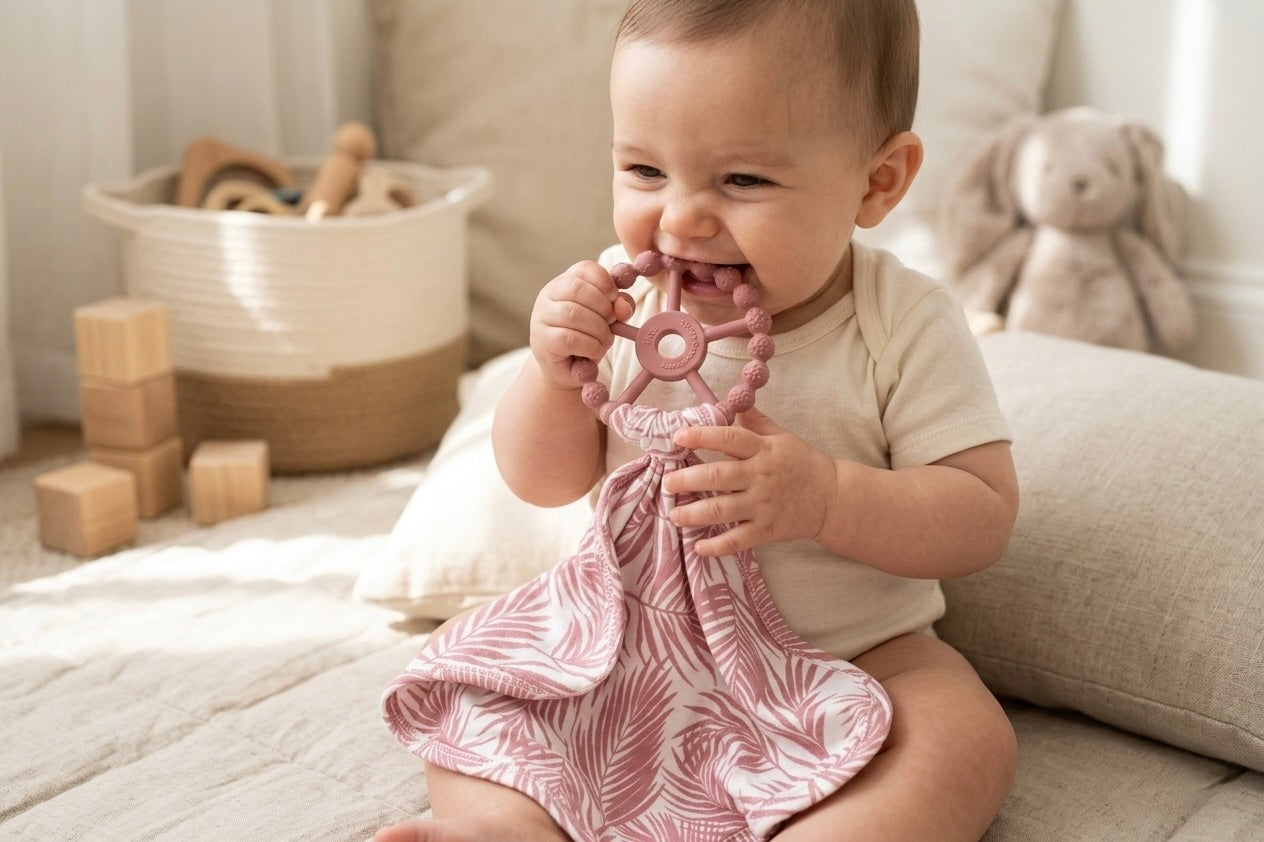 Luxury bamboo baby lovey with pacifier holder in Shae & Palmer’s Cali Coastal Pink palm leaf pattern.