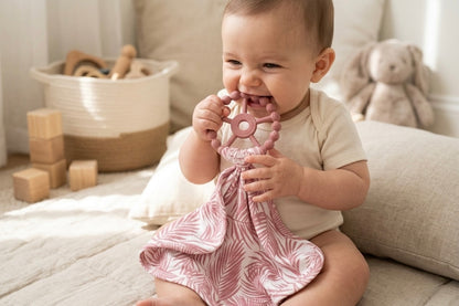 Luxury bamboo baby lovey with pacifier holder in Shae & Palmer’s Cali Coastal Pink palm leaf pattern.