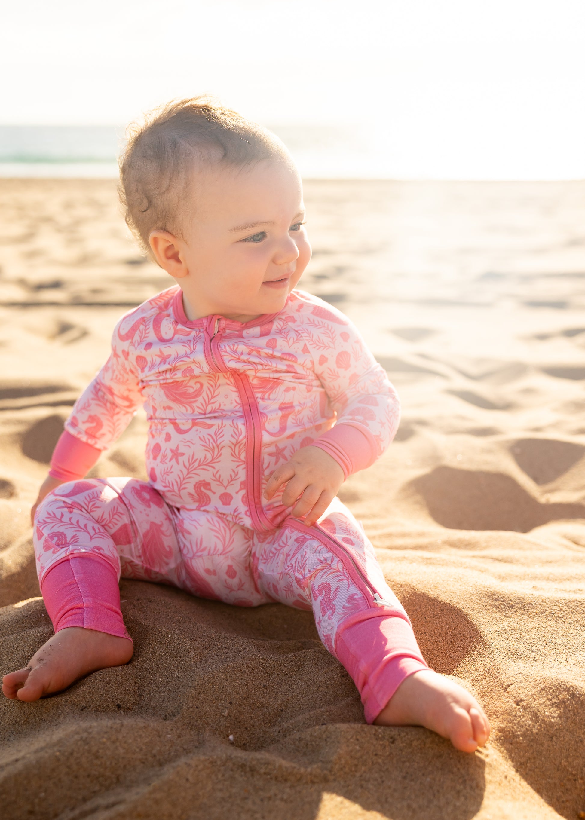 Close-up of Shae & Palmer Mermaid Cove bamboo baby romper with whimsical mermaids, seashells, and buttery-soft bamboo fabric detail