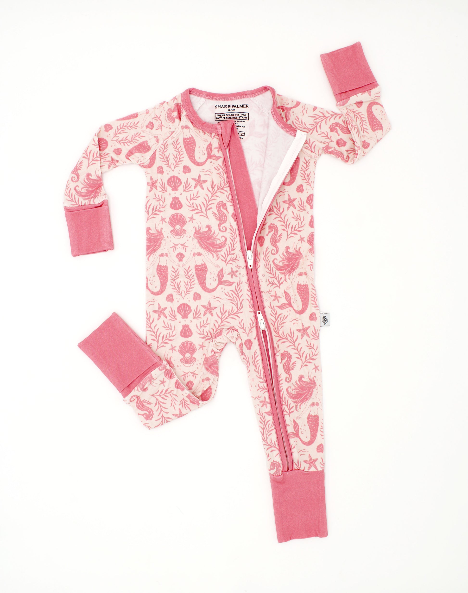 Baby wearing Mermaid Cove bamboo pajamas with mermaid and seashell print, soft breathable baby sleepwear designed for comfort and movement