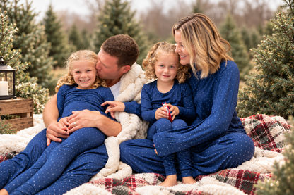 Family wearing matching Midnight Dot navy Hanukkah and Christmas pajamas for holiday celebrations