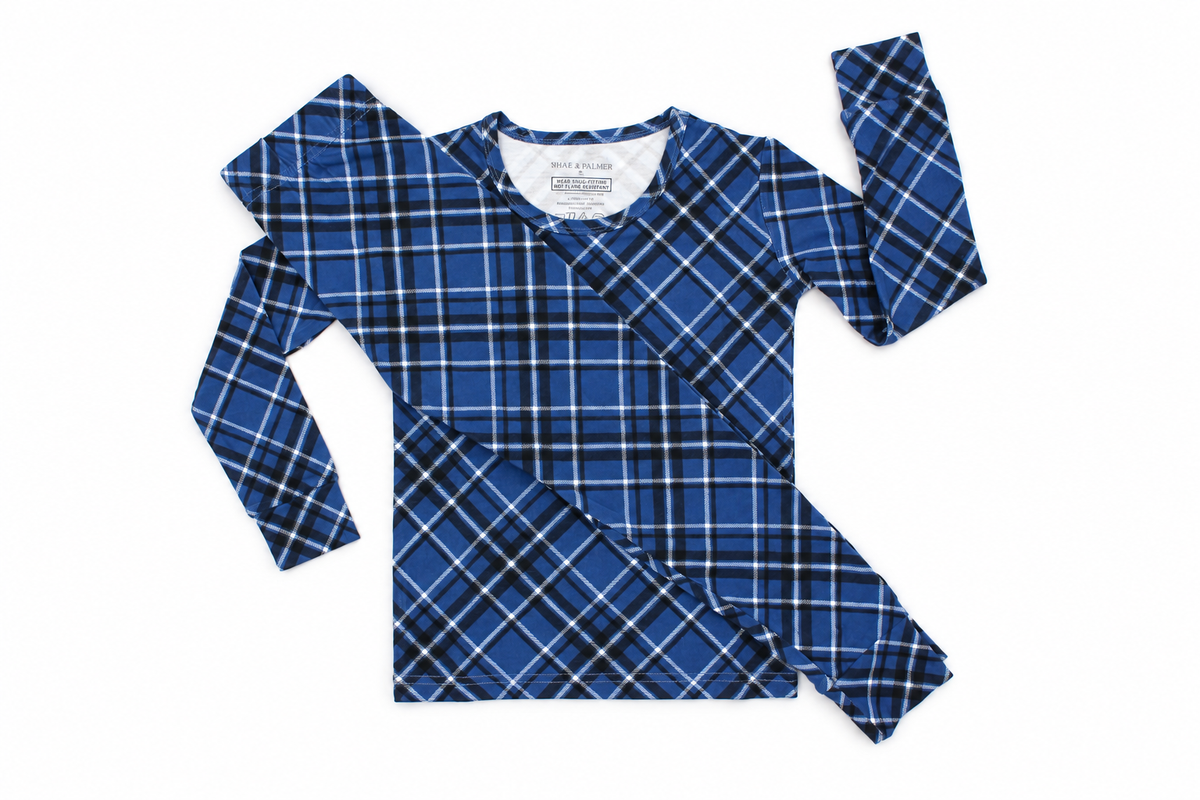 Midnight Plaid toddler bamboo pajama set in navy blue displayed in a flat lay for Christmas and Hanukkah