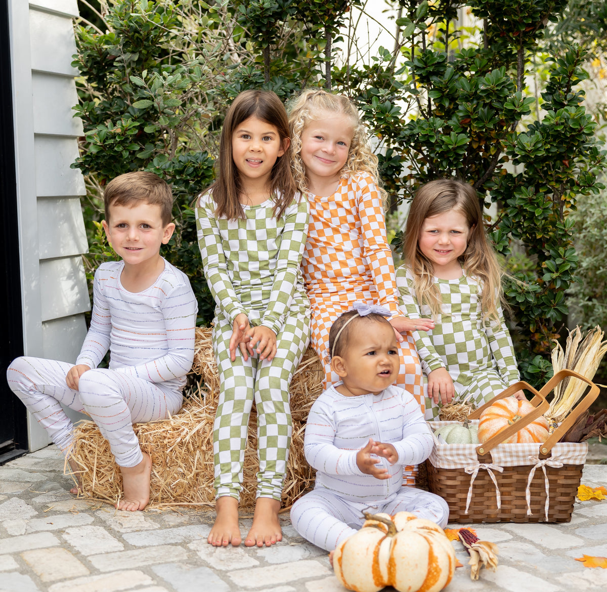 Toddler in cozy Orchard Checkered green and ivory bamboo pajamas, perfect for fall nights and slow mornings.