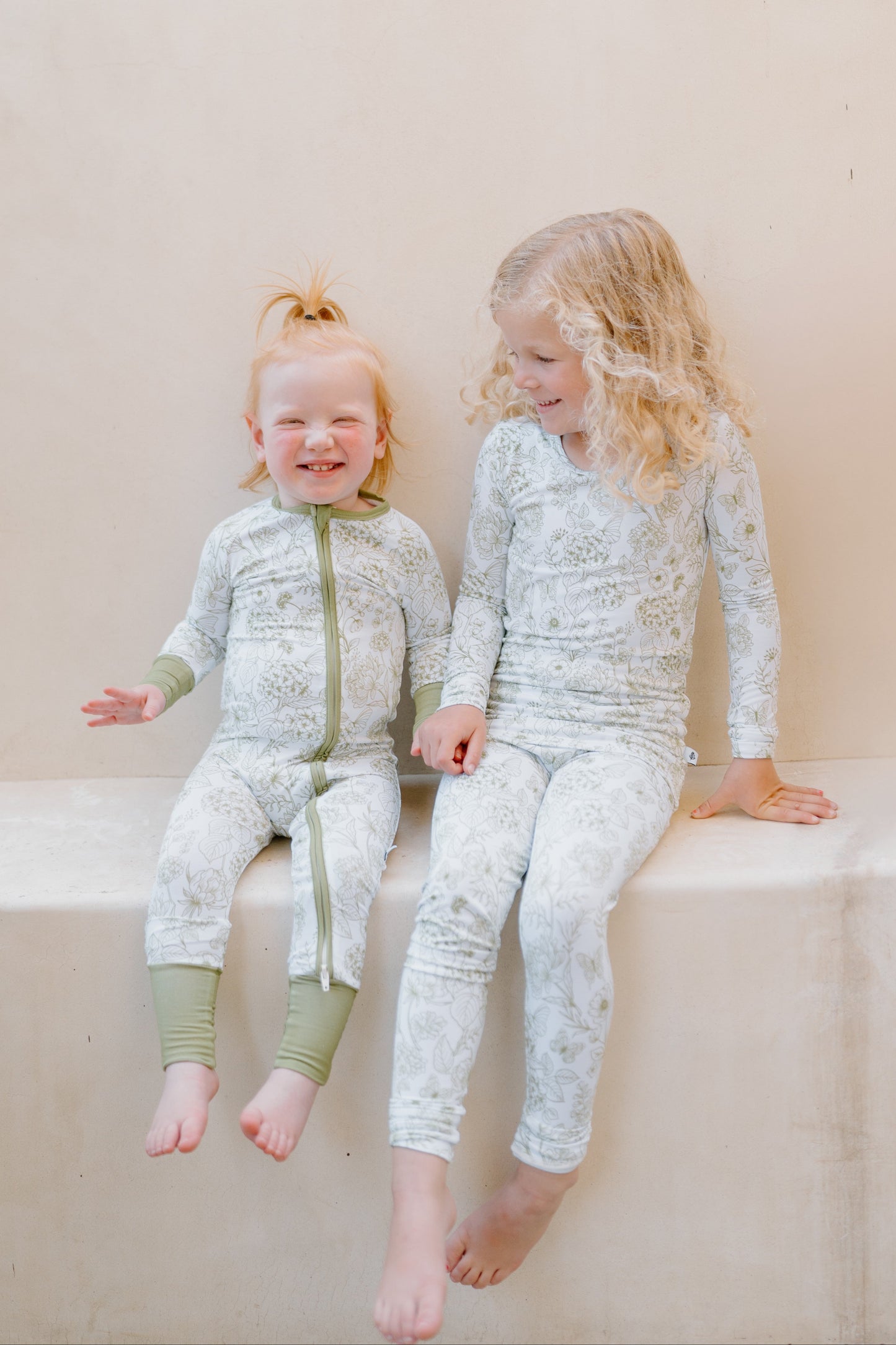 Baby and toddler bamboo pajamas in soft green floral print - Shae & Palmer Botanical Collection in Moss Green, breathable luxury sleepwear for girls, perfect for bedtime and playtime.