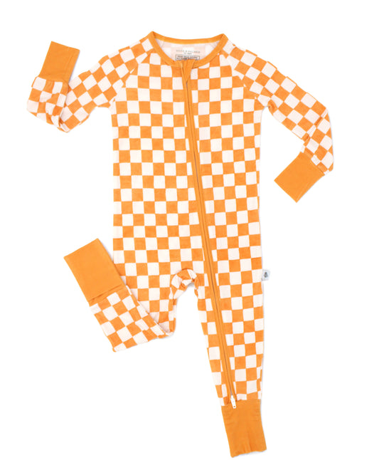 Pumpkin Patch baby bamboo pajamas in an orange and ivory checkered print, shown in a flat lay