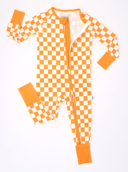 Pumpkin Patch baby bamboo pajamas shown in a flat lay with a convenient front zipper and orange and ivory checkered print.