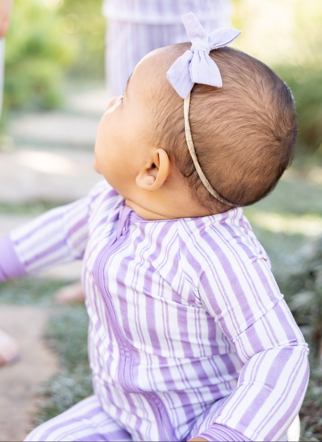 Baby in Shae & Palmer Purple Haze Studio Stripe bamboo zipper romper featuring soft muted purple hand-painted stripes, double zipper closure, and breathable temperature-regulating bamboo fabric.