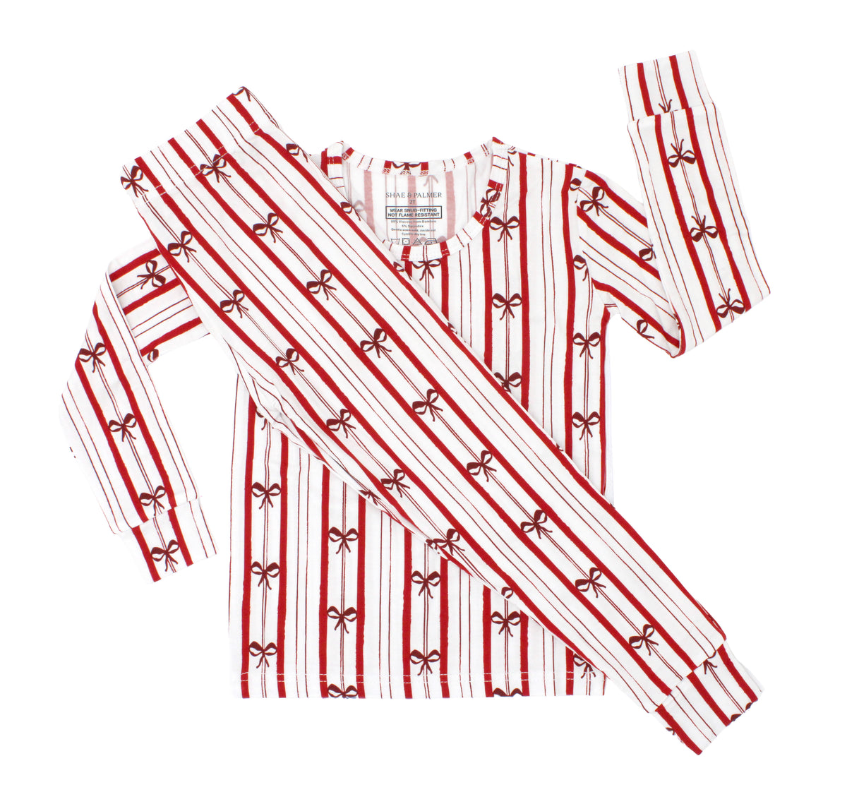 Ribbon Stripe bamboo toddler pajamas by Shae & Palmer featuring classic red and ivory stripes with delicate bows. Soft, breathable Christmas toddler pajamas perfect for matching family holiday pajama sets, Christmas morning, festive family photos, and cozy winter nights.