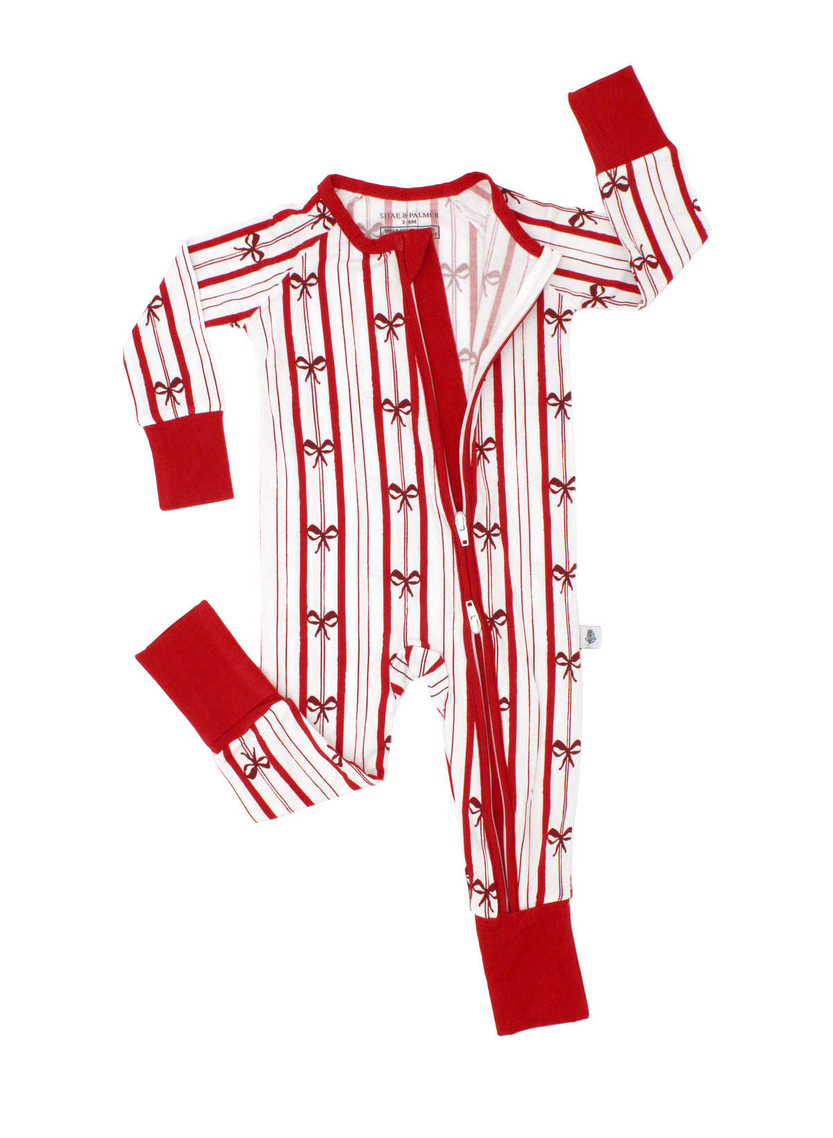 Close-up of the Ribbon Stripe bamboo baby romper by Shae & Palmer showcasing the convenient double zipper closure and delicate red and ivory bow print. Soft, breathable holiday baby pajamas designed for easy diaper changes and comfortable sleep.