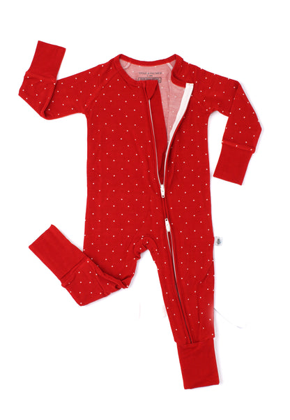 Close-up flat lay of the Ruby Dot Christmas bamboo baby romper by Shae & Palmer, showcasing the convenient double zipper closure and delicate red dot holiday print. Soft, breathable Christmas baby pajamas designed for comfortable holiday nights and easy diaper changes. Matching family pjs