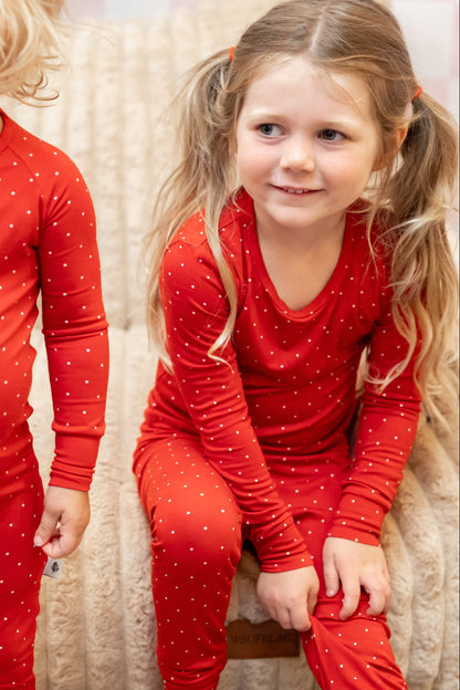 Ruby Dot bamboo toddler pajamas by Shae & Palmer featuring a classic ruby red polka dot print. Soft, breathable Christmas pajamas perfect for matching family holiday sets, Christmas morning, festive photos, and cozy winter nights.