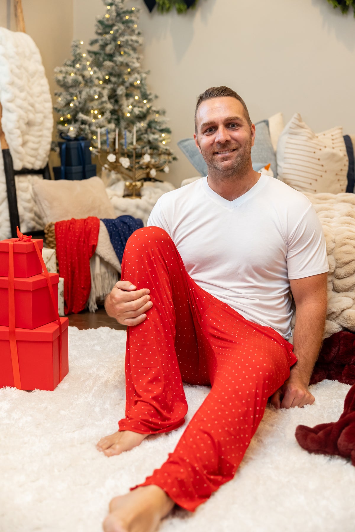 Ruby Dot matching family Christmas pajamas by Shae & Palmer featuring a classic red polka dot print on soft, breathable bamboo. Men's holiday pajamas coordinating with baby, toddler, big kid, and women's pajamas.