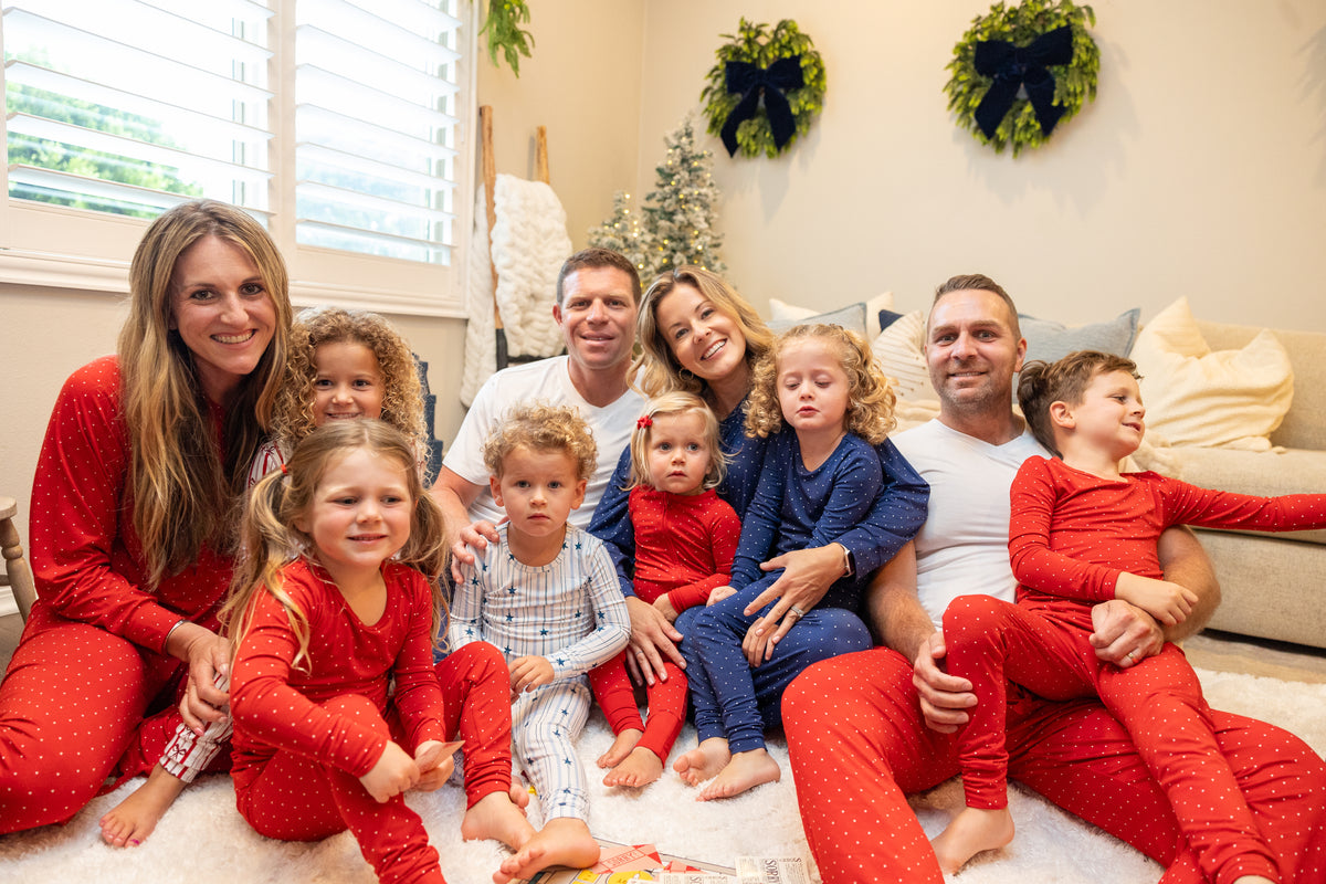Ruby Dot matching family Christmas pajamas by Shae & Palmer featuring festive red polka dots on buttery-soft bamboo. Women's pajamas coordinating with baby, toddler, and big kid holiday pajamas.