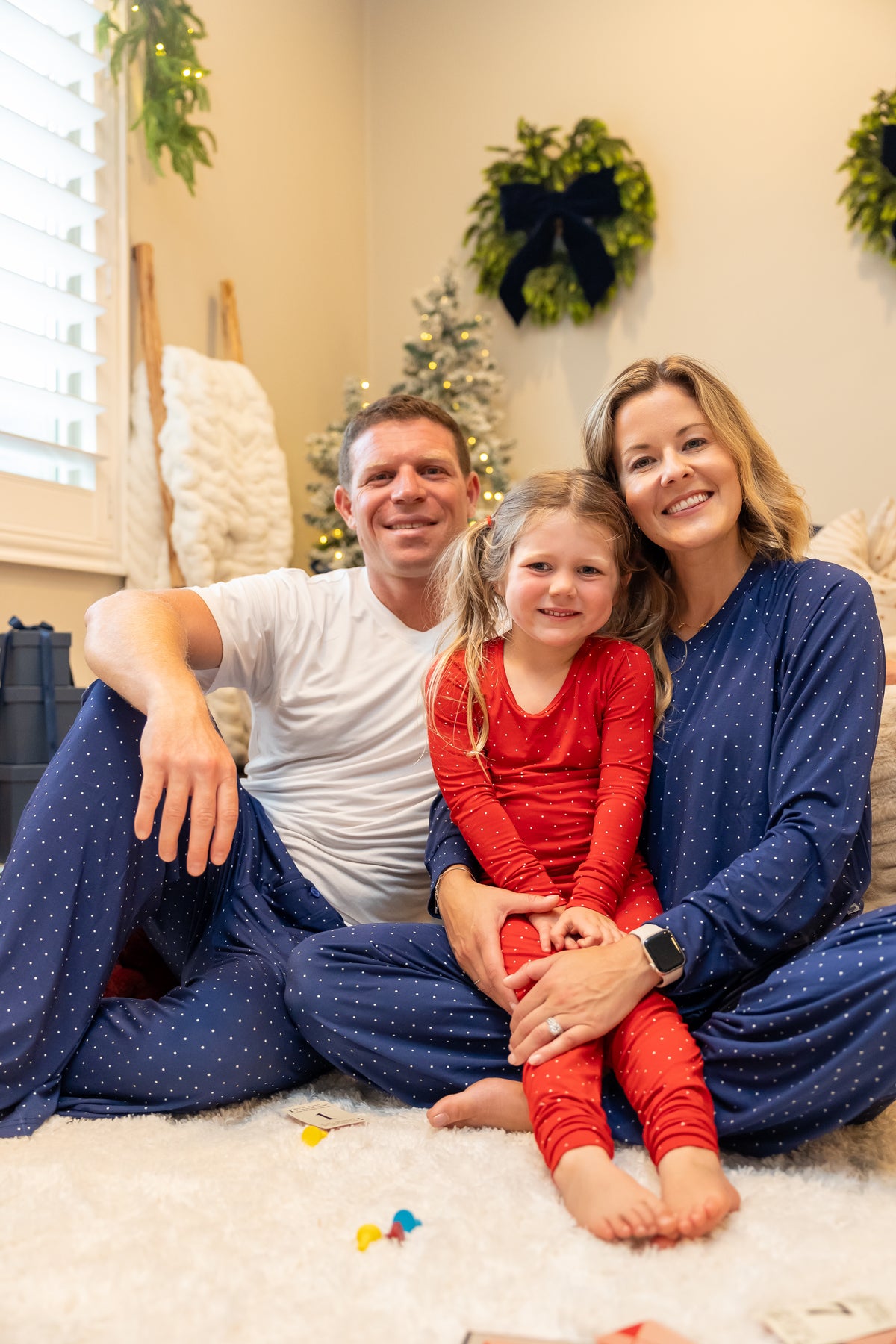 Family wearing coordinating Ruby Dot and Midnight Dot bamboo pajamas by Shae & Palmer, featuring classic red and navy polka dot prints. Soft, breathable matching family Christmas and Hanukkah pajamas perfect for holiday family photos, cozy nights, and festive mornings.